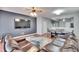 Living room with sectional sofa, large TV, and hardwood floors at 4950 Pond Ridge Dr, Riverview, FL 33578
