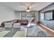 Living room with sectional sofa, sliding glass doors to patio, and hardwood floors at 4950 Pond Ridge Dr, Riverview, FL 33578