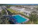 Community pool with surrounding patio and homes at 4950 Pond Ridge Dr, Riverview, FL 33578