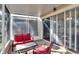 Cozy screened porch features red cushioned furniture at 4950 Pond Ridge Dr, Riverview, FL 33578
