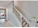 Staircase with chair lift and gray carpeting at 4950 Pond Ridge Dr, Riverview, FL 33578