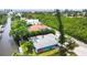 Aerial view showcasing a canal-front home with lush landscaping at 616 Lyons Ln, Longboat Key, FL 34228