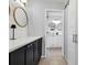 Modern bathroom with dark vanity and white cabinets at 616 Lyons Ln, Longboat Key, FL 34228