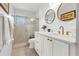 Modern bathroom with a stylish vanity, a large mirror, and a walk-in shower at 616 Lyons Ln, Longboat Key, FL 34228