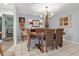 Bright dining room with a wooden table and chairs, showcasing stylish wall art at 616 Lyons Ln, Longboat Key, FL 34228