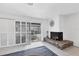 Gathering room with a fireplace and sliding doors leading to the pool area at 616 Lyons Ln, Longboat Key, FL 34228