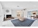Open living room with a fireplace and view into the dining room at 616 Lyons Ln, Longboat Key, FL 34228