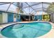 Inviting kidney-shaped pool with a screened enclosure at 616 Lyons Ln, Longboat Key, FL 34228