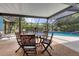 Relaxing screened pool area with patio furniture at 616 Lyons Ln, Longboat Key, FL 34228