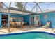 Screened pool and patio with outdoor dining area at 616 Lyons Ln, Longboat Key, FL 34228