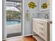 Small bathroom with pool access, vanity, and updated fixtures at 616 Lyons Ln, Longboat Key, FL 34228