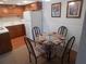 Small dining area with glass-top table and four chairs at 6177 Chesham Dr # 5, New Port Richey, FL 34653