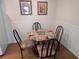 Simple dining area with round glass table and chairs at 6177 Chesham Dr # 5, New Port Richey, FL 34653