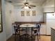 Dining area with glass-top table and four chairs, near the kitchen at 6177 Chesham Dr # 6, New Port Richey, FL 34653