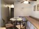 Small dining area with glass-top table and four chairs at 6177 Chesham Dr # 6, New Port Richey, FL 34653