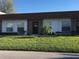 Exterior view of condo, featuring a brown roof and well-maintained lawn at 6177 Chesham Dr # 6, New Port Richey, FL 34653