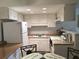 Bright kitchen featuring white cabinets and a breakfast nook at 6177 Chesham Dr # 6, New Port Richey, FL 34653