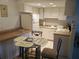 View of kitchen with white cabinets, laminate counters, and breakfast table at 6177 Chesham Dr # 6, New Port Richey, FL 34653