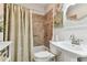 Clean bathroom with beige tile, shower/tub combo, and white vanity at 7318 Filbert Ln, Tampa, FL 33637