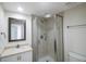 Clean bathroom, shower stall, white vanity, and toilet at 7902 Sailboat Key S Blvd # 405, South Pasadena, FL 33707