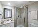 Clean bathroom, shower stall, white vanity, and toilet at 7902 Sailboat Key S Blvd # 405, South Pasadena, FL 33707