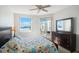 Bedroom with water views, ceiling fan, and dresser at 7902 Sailboat Key S Blvd # 405, South Pasadena, FL 33707