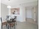 Dining room with glass table and four chairs, open to living area at 7902 Sailboat Key S Blvd # 405, South Pasadena, FL 33707