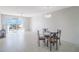 Dining area with glass table and four chairs, near sliding doors at 7902 Sailboat Key S Blvd # 405, South Pasadena, FL 33707