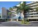 Attractive building exterior with lush landscaping and parking at 7902 Sailboat Key S Blvd # 405, South Pasadena, FL 33707