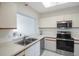 Kitchen with stainless steel appliances and light cabinets at 7902 Sailboat Key S Blvd # 405, South Pasadena, FL 33707