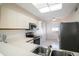 Kitchen boasts stainless steel appliances and a double sink at 7902 Sailboat Key S Blvd # 405, South Pasadena, FL 33707