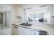 Kitchen with stainless steel appliances and a pass-through window at 7902 Sailboat Key S Blvd # 405, South Pasadena, FL 33707