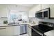 Modern kitchen featuring stainless steel appliances and light wood cabinets at 7902 Sailboat Key S Blvd # 405, South Pasadena, FL 33707