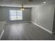 Bright and airy living room with gray walls and vinyl plank flooring at 8239 Brentwood Rd # 8239, Seminole, FL 33777