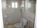 Clean bathroom with shower and toilet, featuring yellow tile at 215 176Th Terrace E Dr, Redington Shores, FL 33708