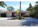 Single-story home with a spacious yard and palm trees at 215 176Th Terrace E Dr, Redington Shores, FL 33708