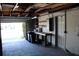 Garage with open door, workbench, and storage shelving at 215 176Th Terrace E Dr, Redington Shores, FL 33708