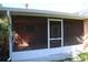 Spacious screened-in porch with tiled floor and access door at 215 176Th Terrace E Dr, Redington Shores, FL 33708