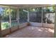 A screened porch with tiled flooring and view of backyard at 215 176Th Terrace E Dr, Redington Shores, FL 33708
