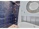 Bathroom with blue tile shower and a soaking tub at 226 5Th N Ave # 1502, St Petersburg, FL 33701