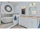 Bathroom with soaking tub, dual vanity, and decorative mirrors at 226 5Th N Ave # 1502, St Petersburg, FL 33701