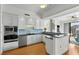Kitchen with white cabinetry, stainless steel appliances, and breakfast bar at 226 5Th N Ave # 1502, St Petersburg, FL 33701