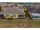 Home's back, featuring a sunroom and expansive yard at 2311 Nottingham Greens Dr # 2311, Sun City Center, FL 33573