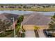 View of home's rear, showcasing a large yard and golf course at 2311 Nottingham Greens Dr # 2311, Sun City Center, FL 33573