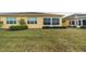 View of house's back, showing a sunroom and yard at 2311 Nottingham Greens Dr # 2311, Sun City Center, FL 33573