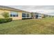 Landscaped yard with multiple houses and sunrooms at 2311 Nottingham Greens Dr # 2311, Sun City Center, FL 33573