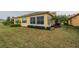 Landscaped backyard with view of sunroom at 2311 Nottingham Greens Dr # 2311, Sun City Center, FL 33573
