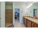 Double vanity bathroom with granite countertops and walk-in shower at 2311 Nottingham Greens Dr # 2311, Sun City Center, FL 33573