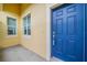 Front entrance with a blue door and two windows at 2311 Nottingham Greens Dr # 2311, Sun City Center, FL 33573