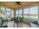 Sunroom with lake view, seating, and ceiling fan at 2311 Nottingham Greens Dr # 2311, Sun City Center, FL 33573